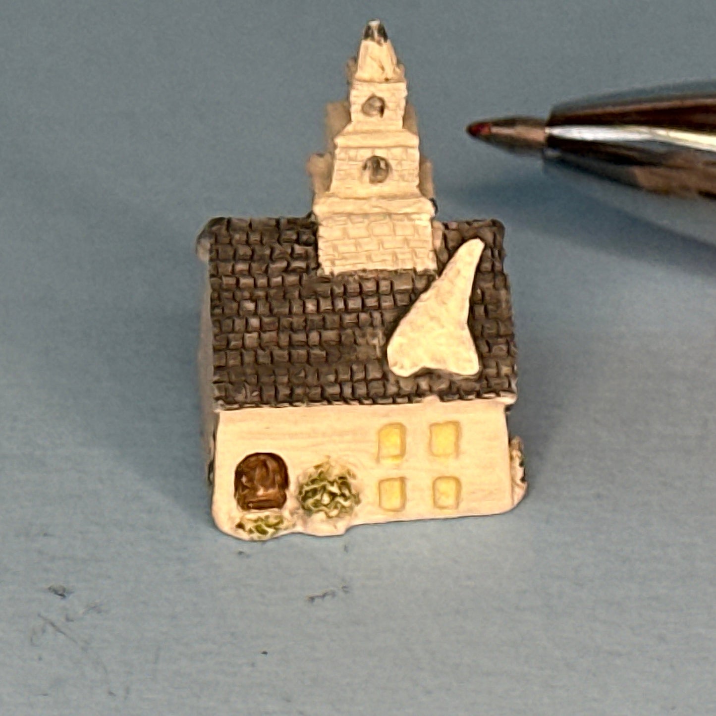Miniature Snow-Covered Church with Gray Roof and Chimney