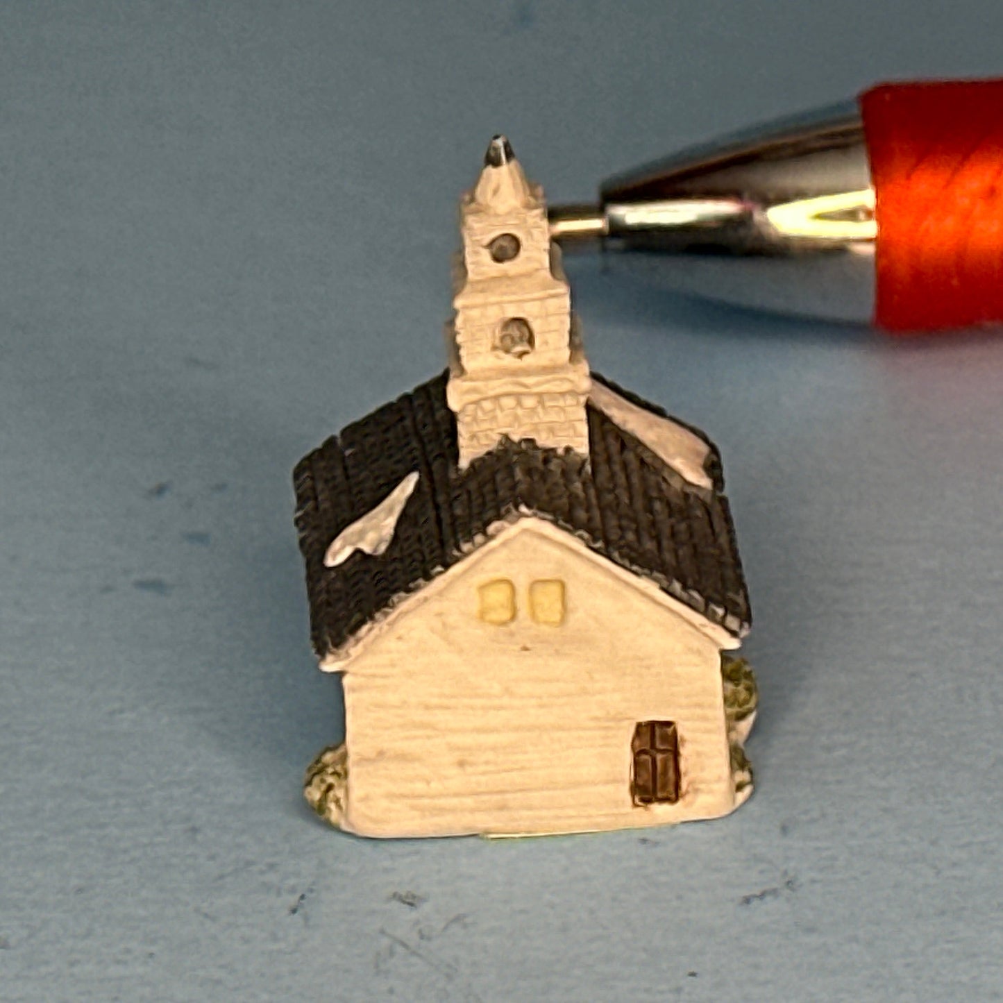 Miniature Snow-Covered Church with Gray Roof and Chimney