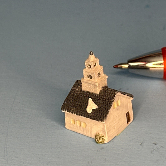 Miniature Snow-Covered Church with Gray Roof and Chimney