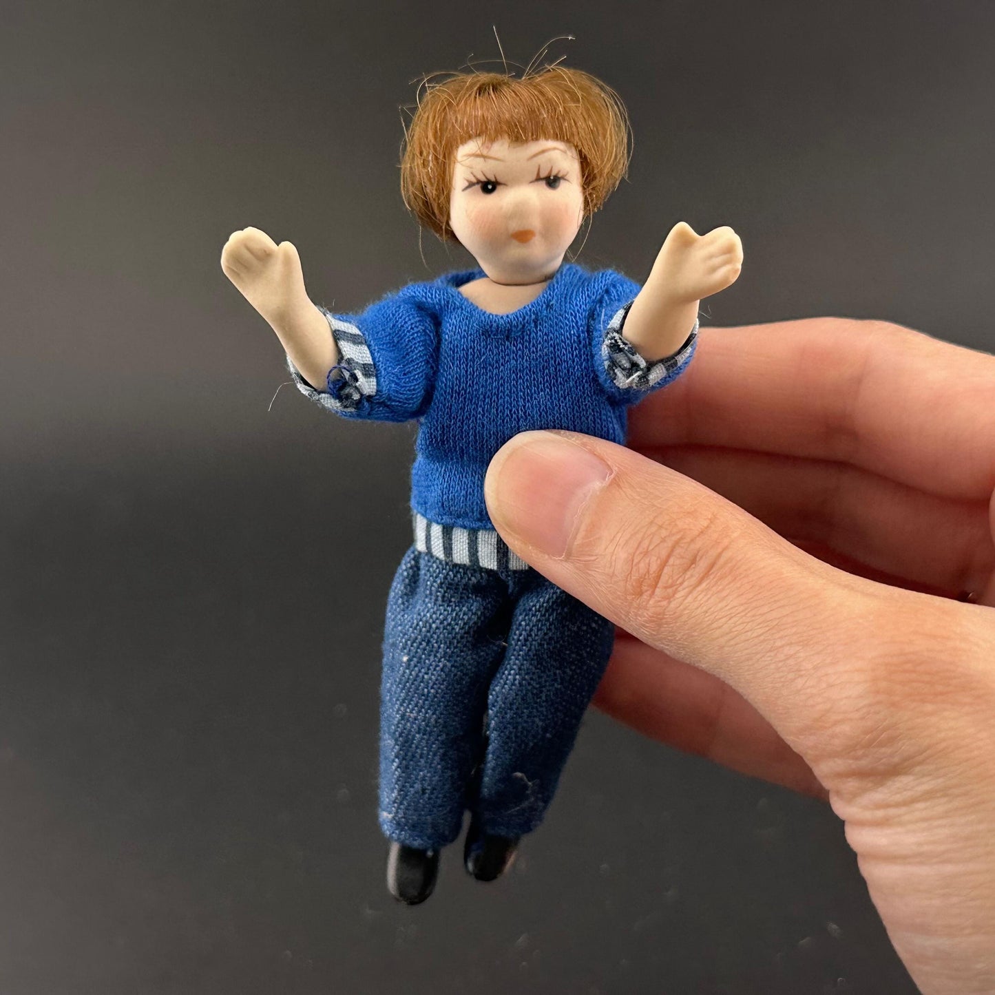 1:12 Scale Porcelain girl Doll – Dollhouse Miniature Child – Movable Head and Limbs – Blue Sweater & Jeans – 4” (10 cm)