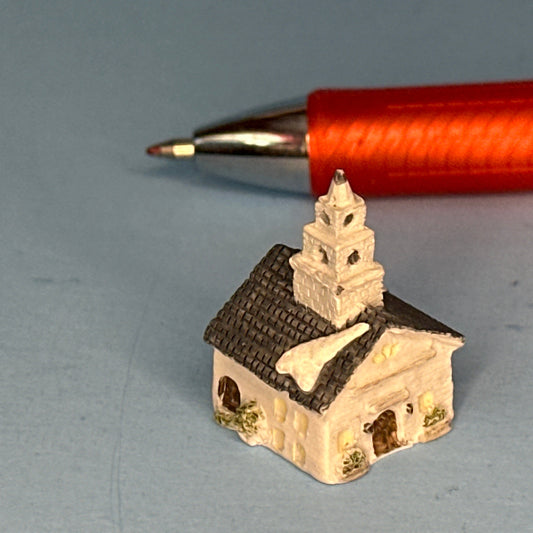 Miniature Snow-Covered Church with Gray Roof and Chimney